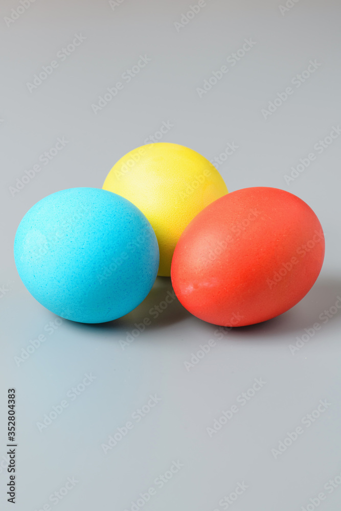 Colorful Easter eggs on a gray background. Easter eggs background. Easter eggs are a symbol and a mandatory attribute of the holiday. Colorful Easter eggs on a gray background. Easter eggs background. Easter eggs are a symbol and a mandatory attribute of the holiday.