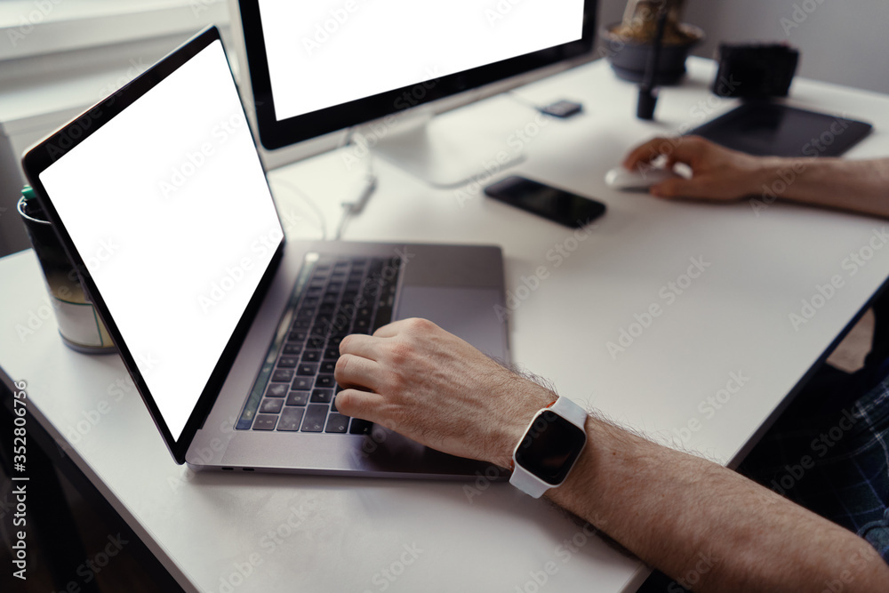 Man hands working on his laptop with blank copy space screen for your advertising text message at home. Home office Man hands working on his laptop with blank copy space screen for your advertising text message at home. Home office