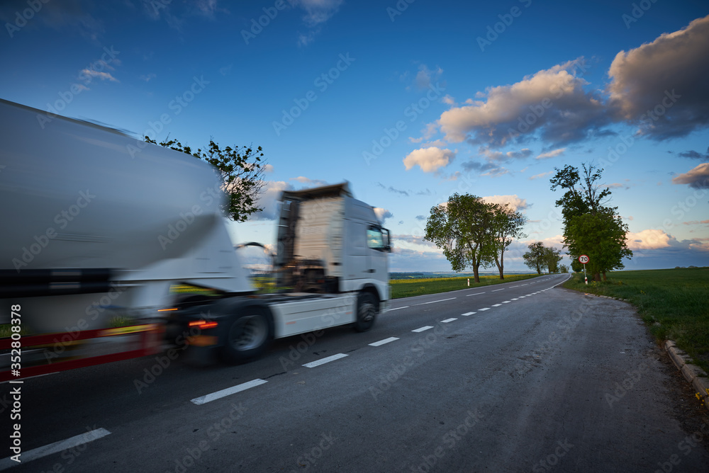 A moving truck on a narrow road