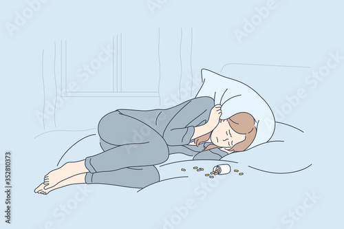 Depression, overdose, frustration, addiction concept. Depressed unhappy frustrated young woman lying on bed with opened bottle of pills. Suffering from insomnia or mental stress psychological problem.