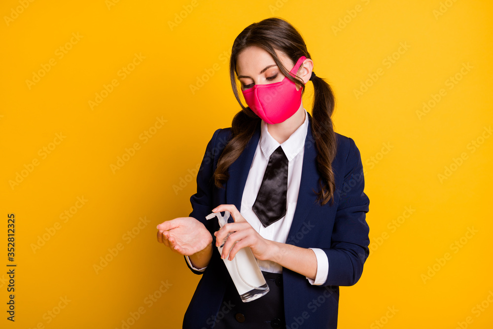 Portrait of her she nice attractive pretty brown-haired schoolgirl wearing pink mask using sanitizer anti bacteria sars ncov covid19 isolated on bright vivid shine vibrant yellow color background Portrait of her she nice attractive pretty brown-haired schoolgirl wearing pink mask using sanitizer anti bacteria sars ncov covid19 isolated on bright vivid shine vibrant yellow color background
