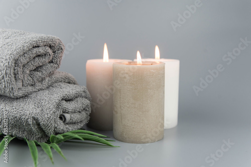 Towel with aromatic candles. Aromatherapy and beauty. Concept set of harmony, massage, balance and meditation, spa, relax, beauty spa treatment.