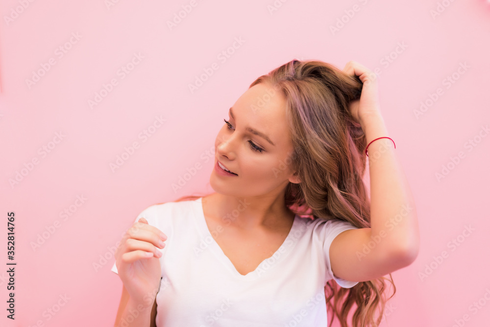 Blonde woman with curly beautiful hair smiling isolated on pink background. Blonde woman with curly beautiful hair smiling isolated on pink background.