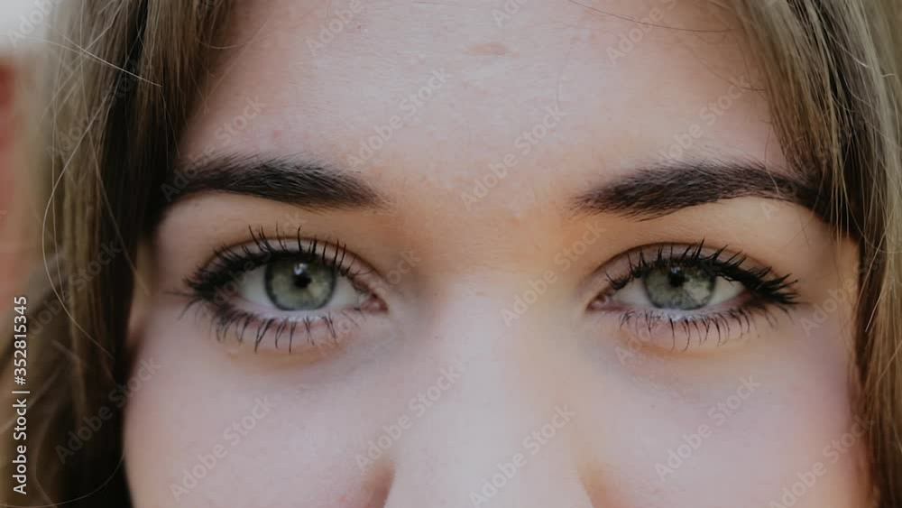 Close-Up of Young Woman’s Grey Eyes, Slow Motion Macro Shot of Female Eyes with Natural Long Eyelashes Close-Up of Young Woman’s Grey Eyes, Slow Motion Macro Shot of Female Eyes with Natural Long Eyelashes