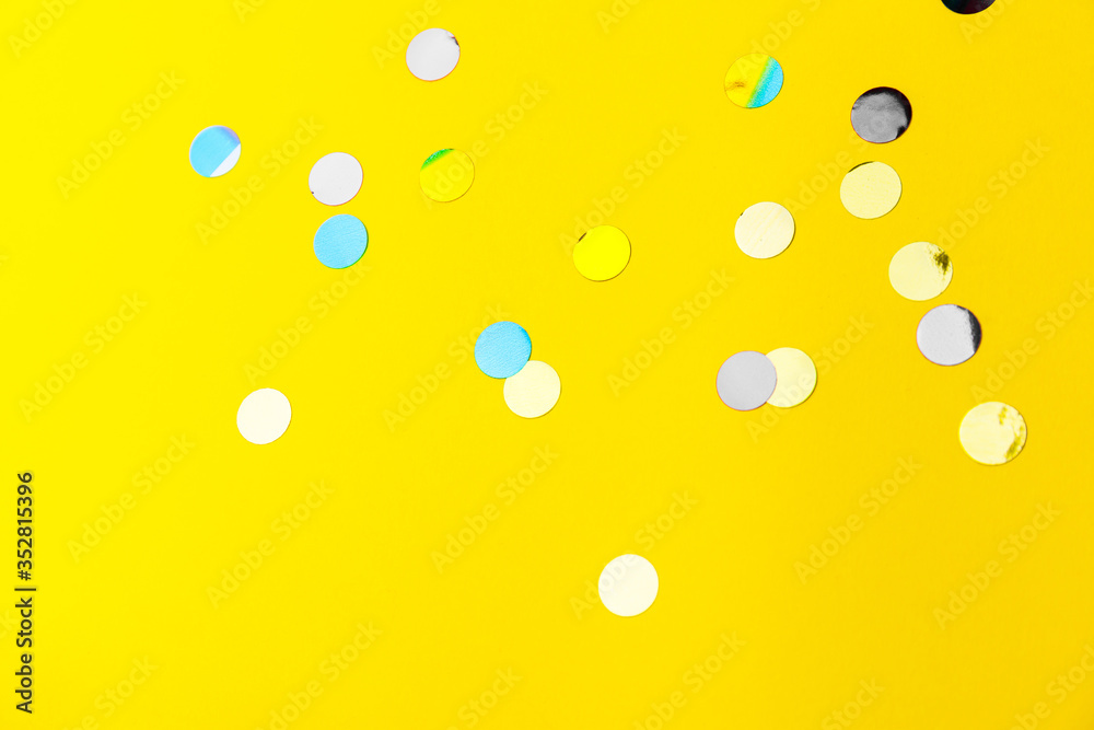 colorful sprinkles over yellow background, decoration for holiday and party
