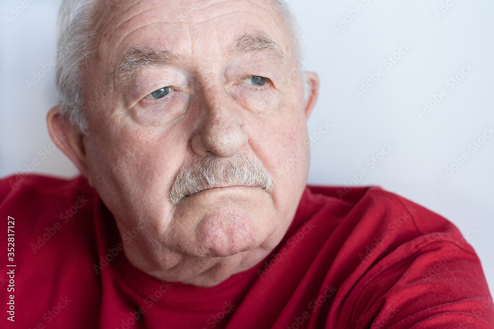 Close up portrait of older man with thoughtful expression Close up portrait of older man with thoughtful expression