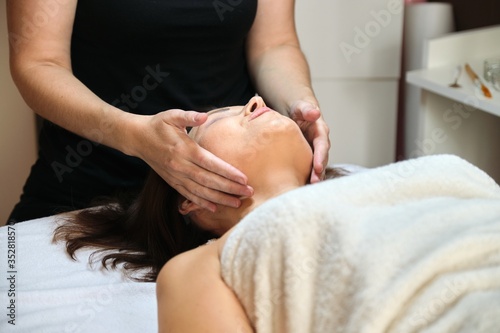 Middle age woman in beauty spa salon, close up face and neck massage