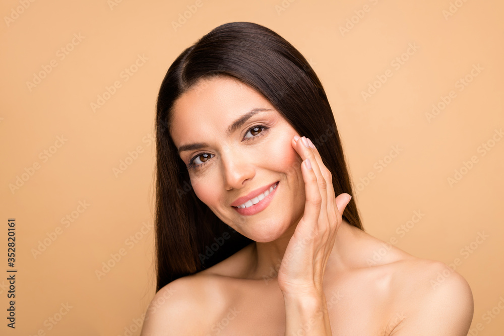Closeup photo of latin mature nude lady natural beauty without makeup touch  cheek pure soft skin applying anti age cream isolated beige pastel color  background Photos | Adobe Stock