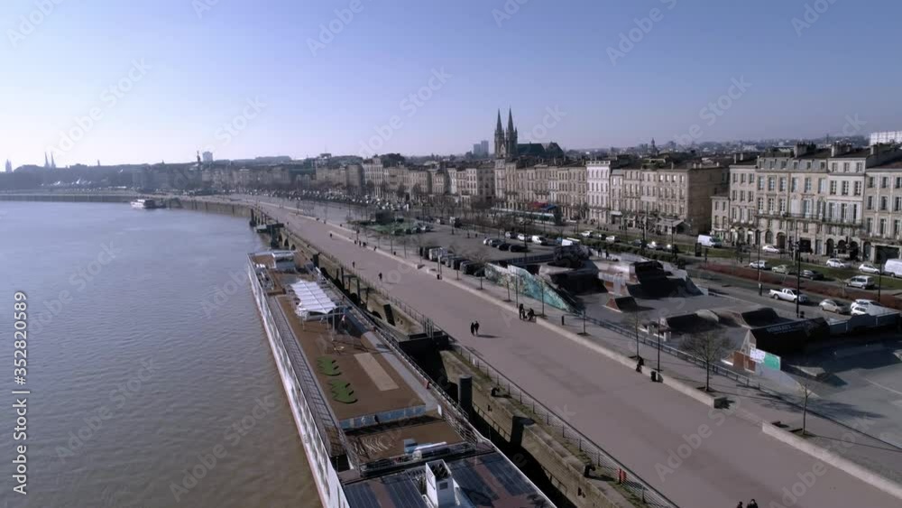 Luxury river cruise on the Garonne river Bordeaux France aside Skate Park Colbert in Quai des Chartrons, Aerial flyover shot