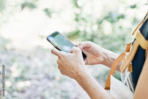 Woman consulting phone in nature