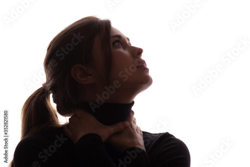 Bilde på lerret portrait face of young beautiful woman in a black with hands clutching neck, lif