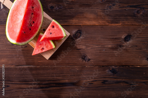 Sliced watermelon on wooden background.
