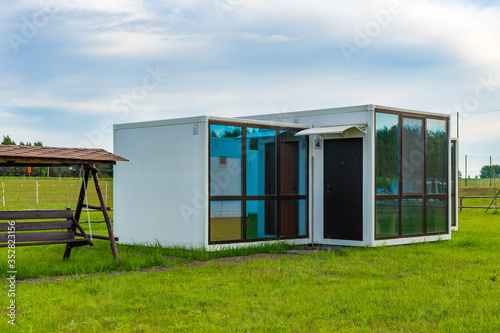 Modular prefabricated houses made of panels with large panoramic windows.