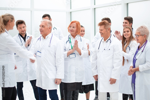 group of medical colleagues discussing their achievements.