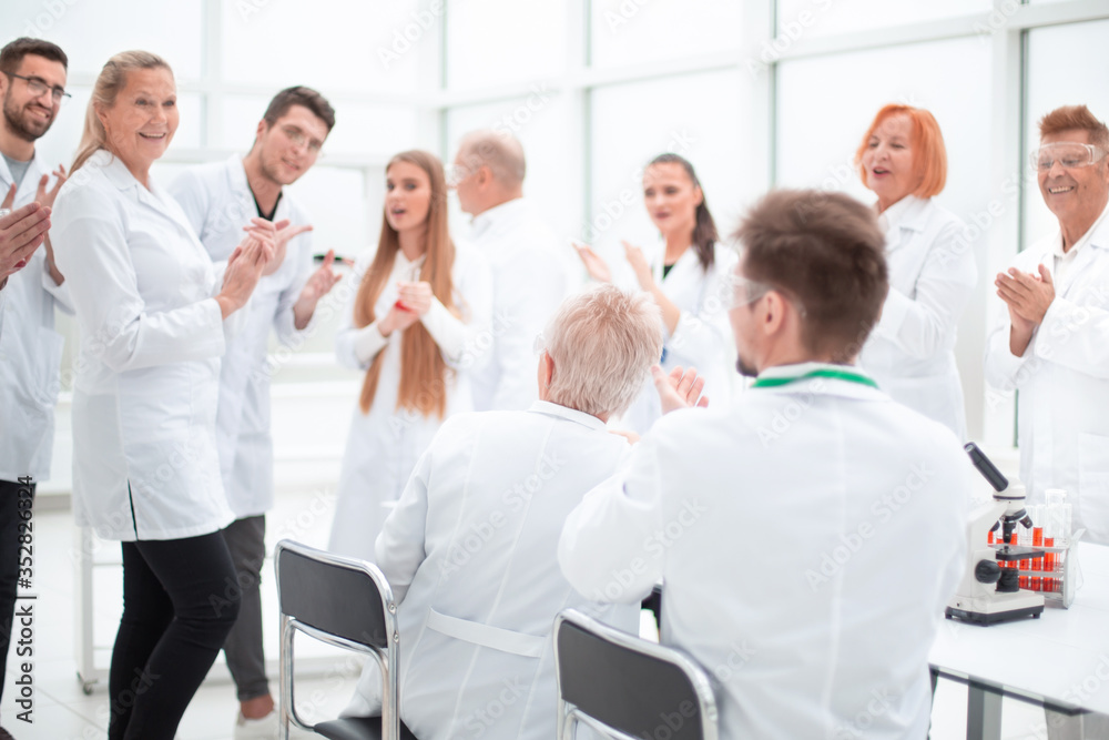 group of researchers discussing new ideas in the laboratory. group of researchers discussing new ideas in the laboratory.