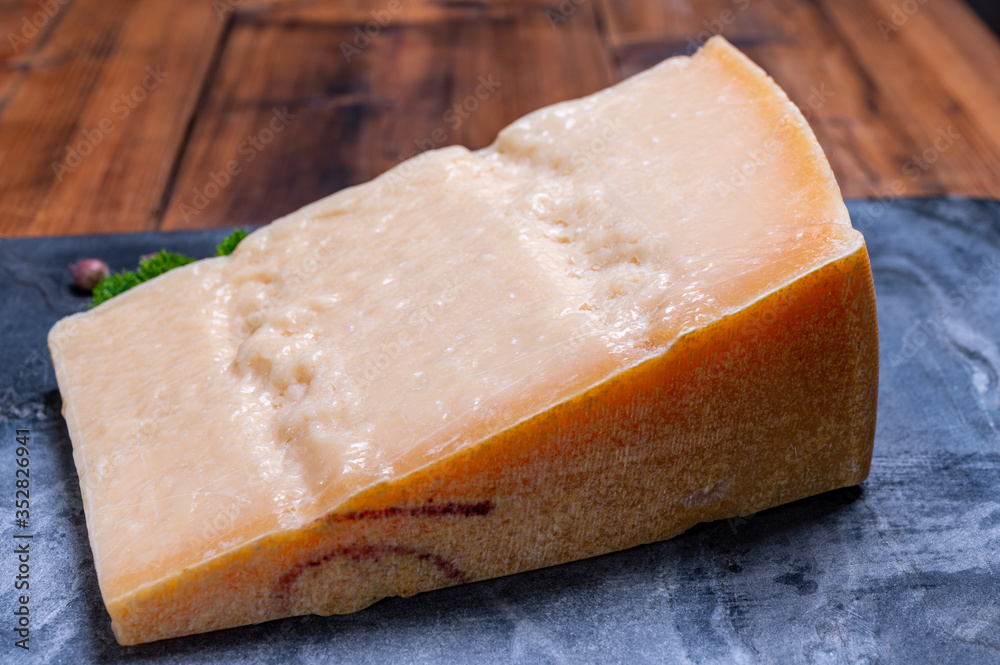 Big wedge of parmigiano-reggiano parmesan hard Italian cheese made from cow milk or Grana Padano