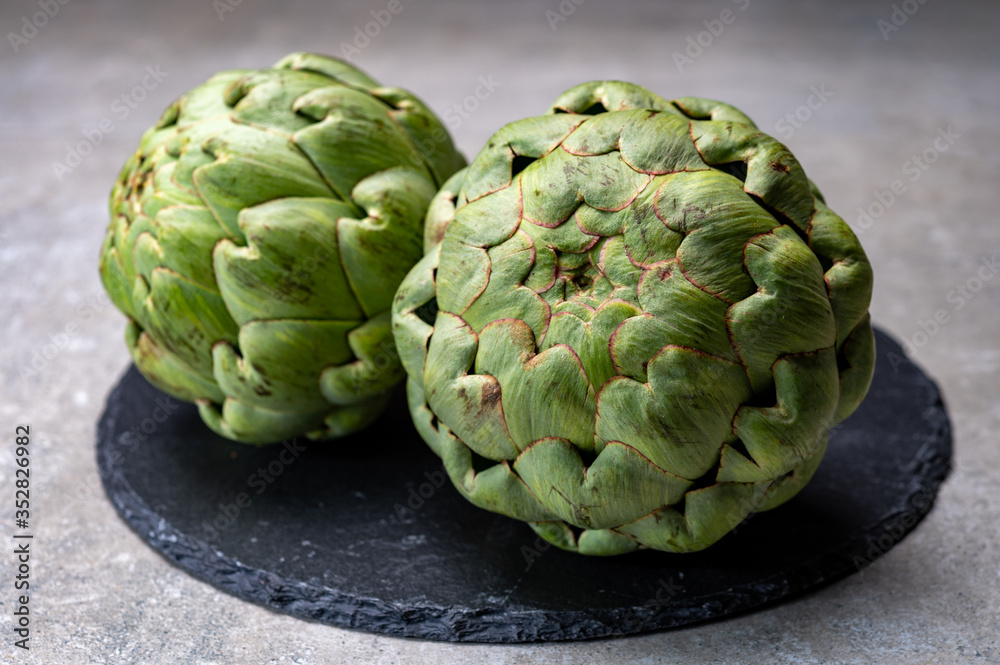 Fototapeta premium Big ripe uncooked green globe artichoks vegetables