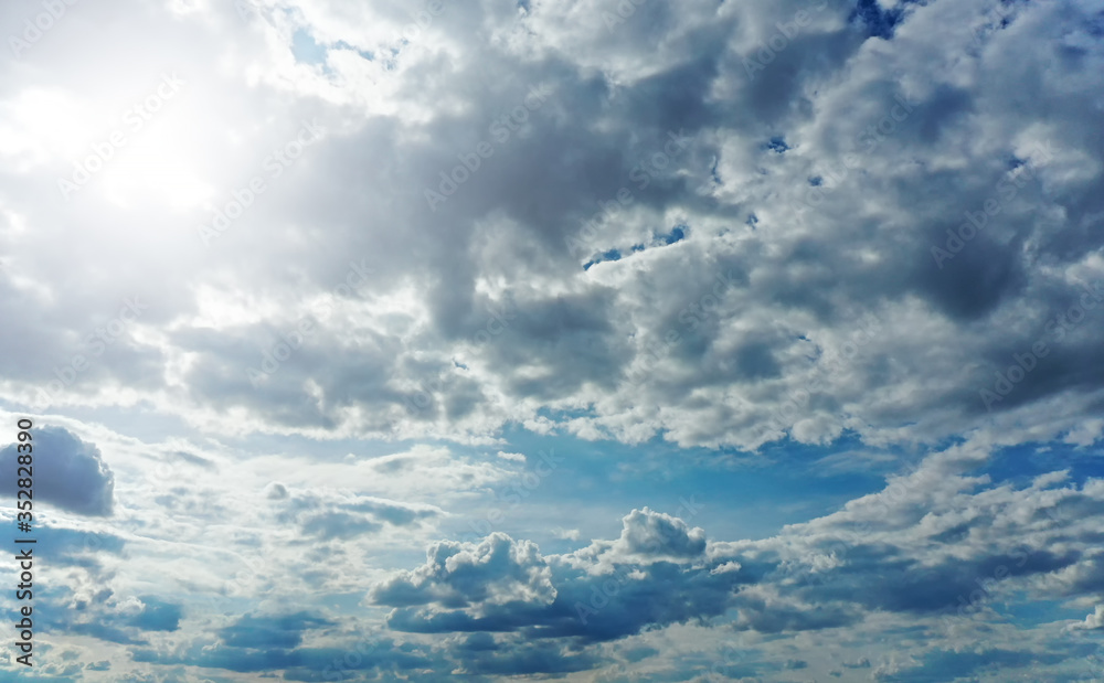 Beautiful blue sky with the sun and thick contrasting clouds Beautiful blue sky with the sun and thick contrasting clouds