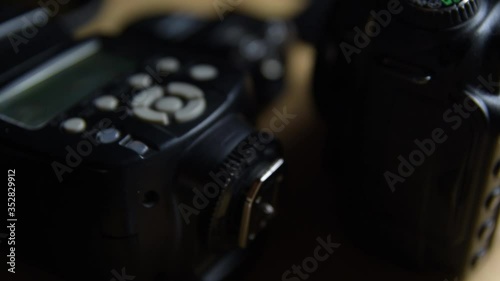 Digital camera, lenses and equipment of the photographer on a dark background photo