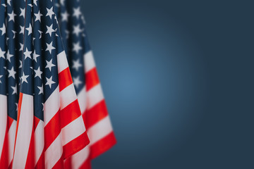 American flags on blue background. Perfect image for Memorial day, Independence Day and Veterans Day.  American patriotism concept.
