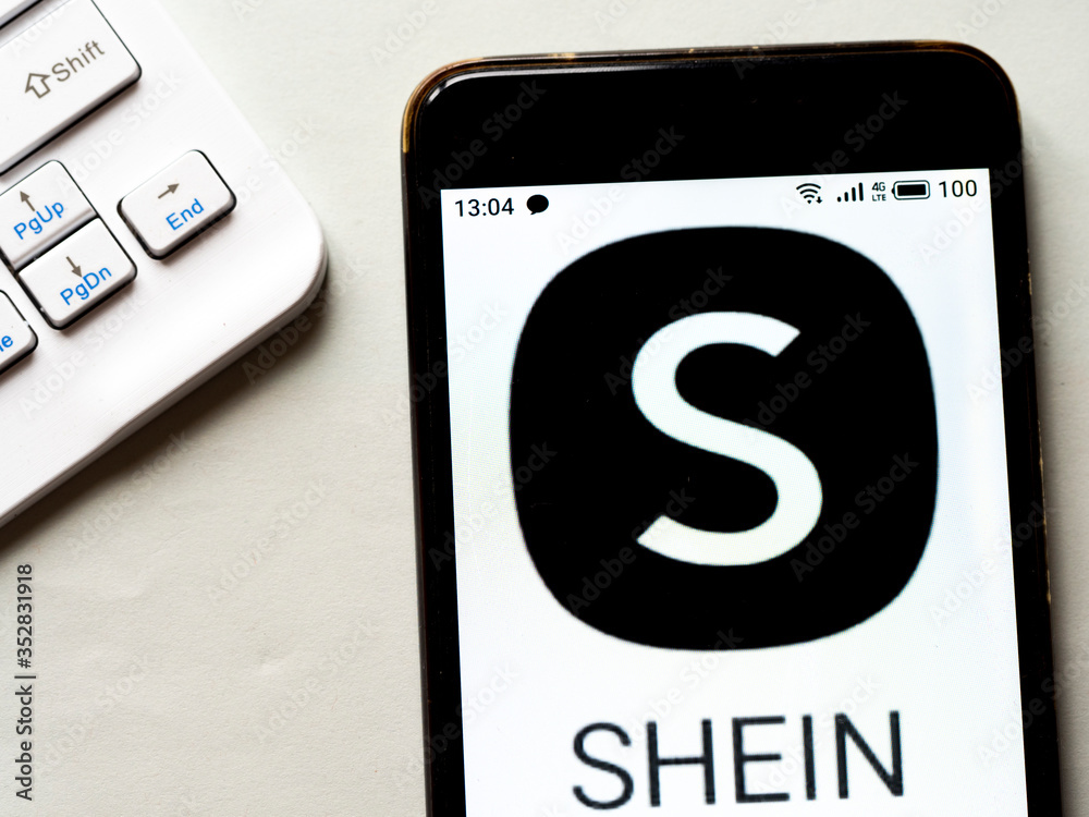 In this photo illustration e-commerce Shein logo is seen displayed on a  smartphone foto de Stock | Adobe Stock