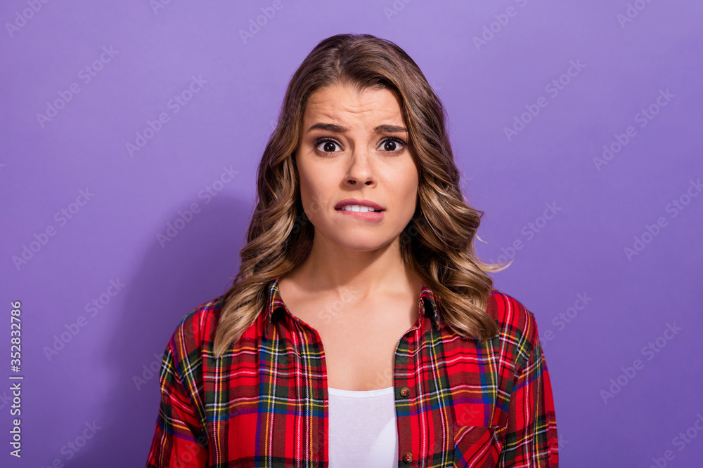 Close-up portrait of her she nice attractive lovely pretty depressed girl in checked shirt biting lip worrying isolated over bright vivid shine vibrant lilac violet purple color background Close-up portrait of her she nice attractive lovely pretty depressed girl in checked shirt biting lip worrying isolated over bright vivid shine vibrant lilac violet purple color background