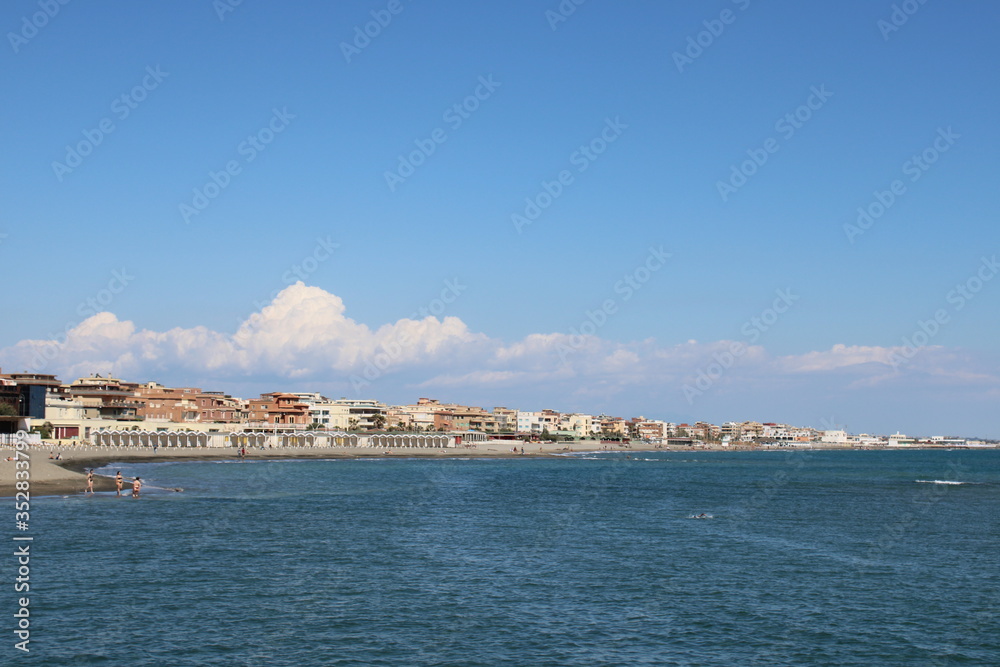 view of beach beautiful view of buildings and blue sea water near rome  Italy 