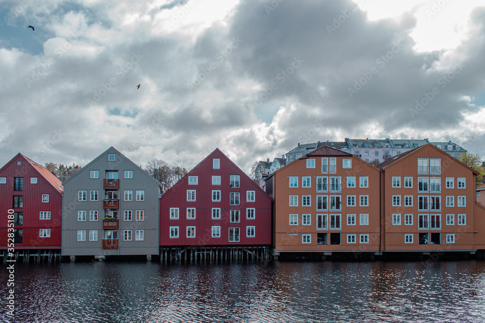 Naklejka premium Trondheim, Norway; May 5 2015: Colorful houses with reflection in the water of Trondheim.