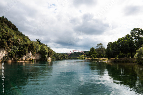 the calm water of Waikato River passing by East Taupo Arterial bridge