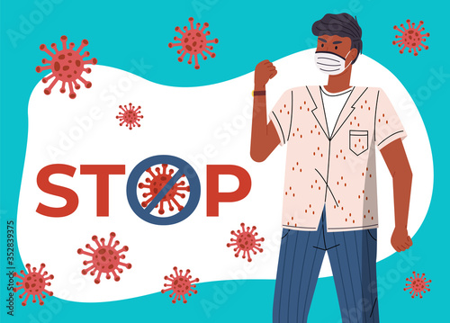 Young black guy wearing medical mask protesting against world epidemic at the background of flying virus and stop sign. Concept of coronavirus spreading. Man show fight gesture, crossed out sign