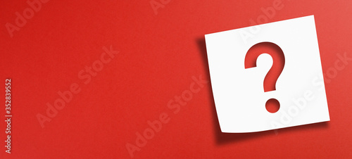 Note paper with question mark on panoramic red background	 photo