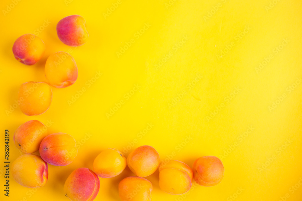 Ripe apricots fruit yellow background