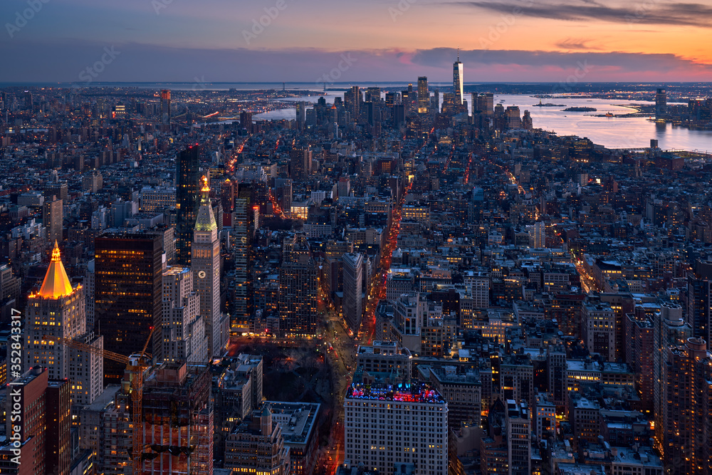 New York City aerial view of the skyscrapers of Manhattan at twilight. The view includes Lower Manhattan, Flatiron District, Midtown and the World Trade Center. NY, USA