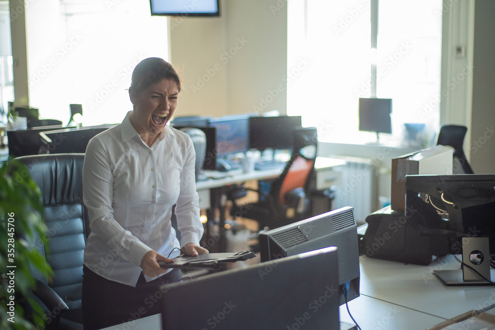 A woman freaks out and gets depressed from a mistake and breaks the keyboard on the monitor. Female manager gets angry and crashes a computer. Office clerk is stressed at work. Unstable psyche. A woman freaks out and gets depressed from a mistake and breaks the keyboard on the monitor. Female manager gets angry and crashes a computer. Office clerk is stressed at work. Unstable psyche.