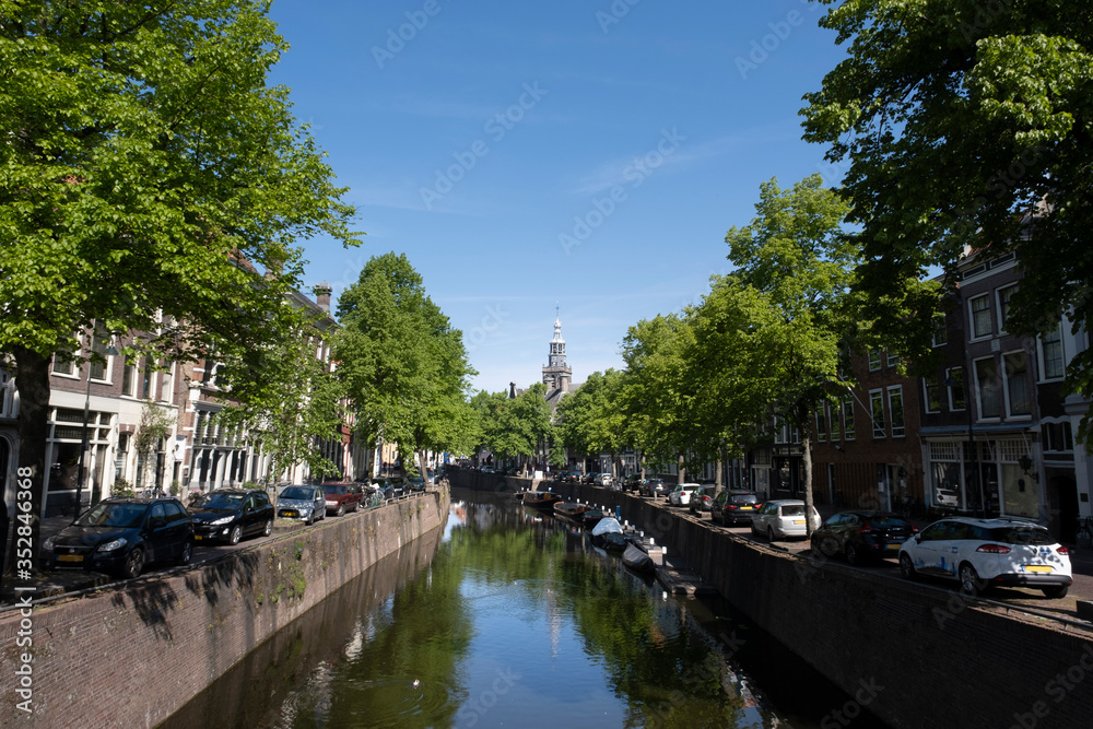 Cityscape of a canal with monumental buildings. Gouda, the Netherlands.