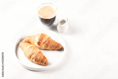 Croissants and coffee in the style of minimalism.