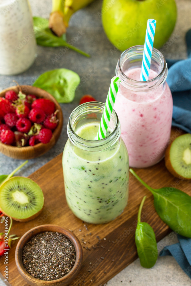 The concept of a healthy diet. Detox smoothies mix. Green smoothies vegetable and fruit smoothies on a stone concrete worktop. The concept of a healthy diet. Detox smoothies mix. Green smoothies vegetable and fruit smoothies on a stone concrete worktop.