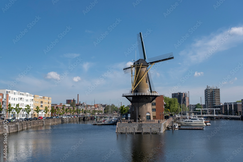 The historic Delfshaven district with windmill in Rotterdam, The Netherlands. South Holland region. Summer sunny day