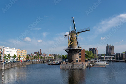 The historic Delfshaven district with windmill in Rotterdam, The Netherlands. South Holland region. Summer sunny day