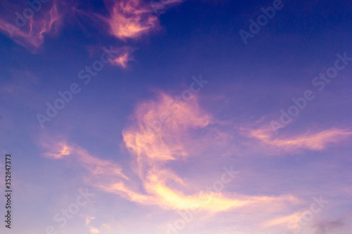 Colorful sunset sky above clouds with dramatic light in twilight time. Beautiful sunset background