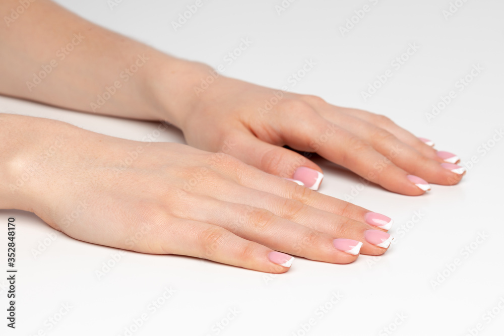 Well-groomed female hands with manicure on white background Well-groomed female hands with manicure on white background