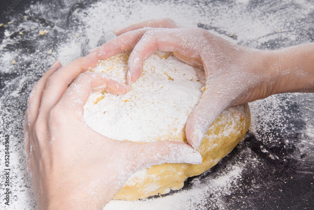 Fototapeta premium woman hands in form of heart on fresh dough