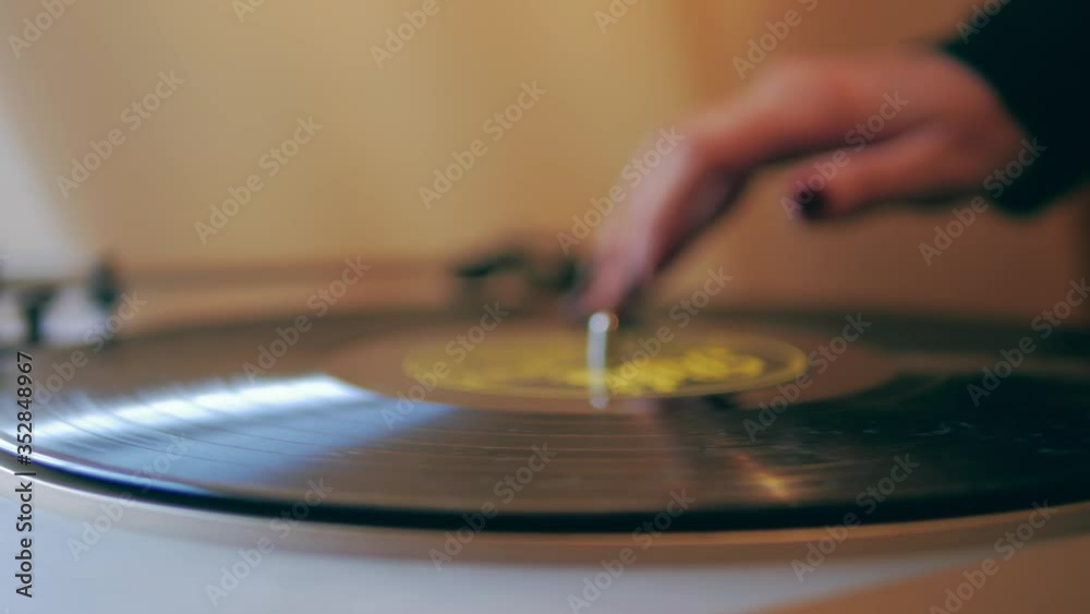girl's hand twists vinyl in a gramophone close-up girl's hand twists vinyl in a gramophone close-up