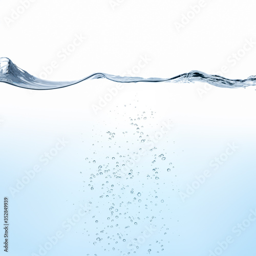 Rippling water surface with bubbles against white background