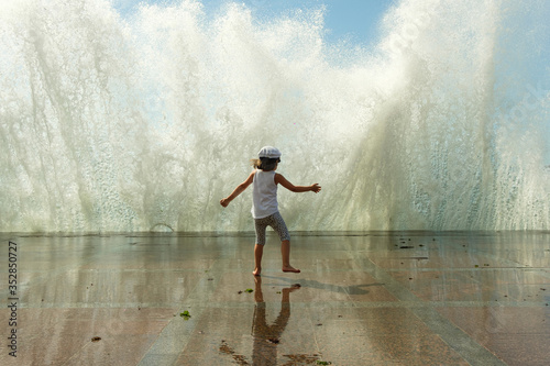 Child plays with the waves