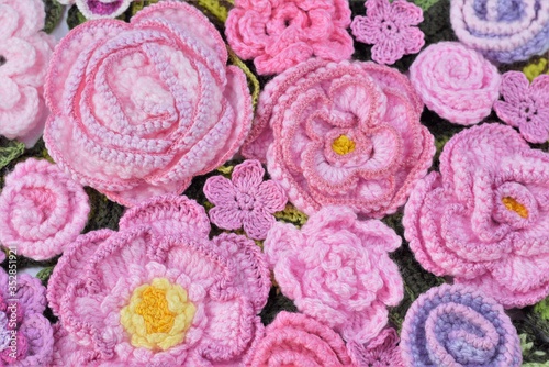 Decorative handmade background from crocheted flowers, floral flat lay. 