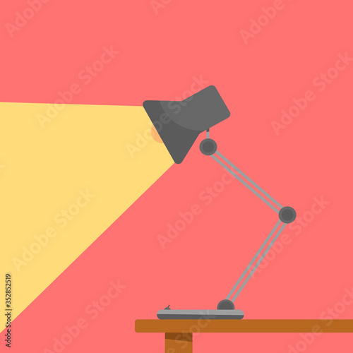 Gray table lamp that shines on the wall