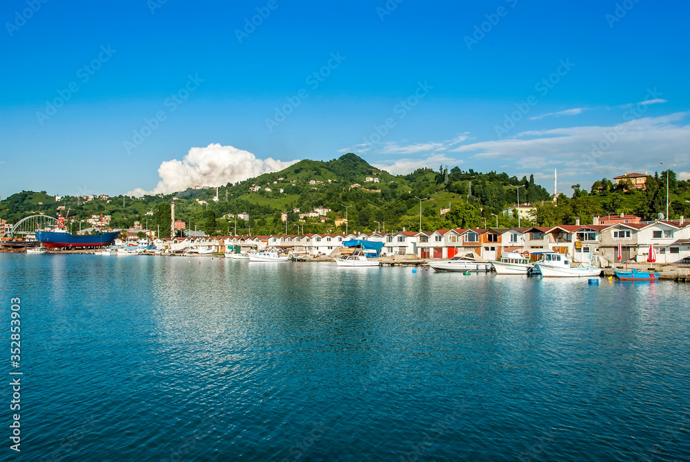 TRABZON, TURKEY - JULY 06, 2012: Fishing Shelter, Boats, Green hills and Buildings. Of District