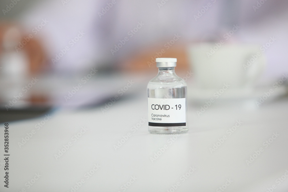  sample covid-19 vaccine vial with medication, closeup.