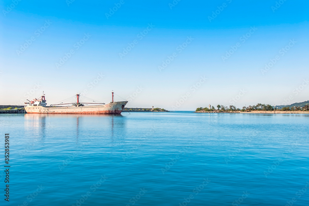 TRABZON, TURKEY - JULY 06, 2012: Harbor, Freighter carrying sea sand, Lighthouses. Of District
